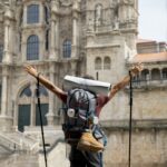 peregrino de espaldas llegando a la catedral de Santiago de Compostela.